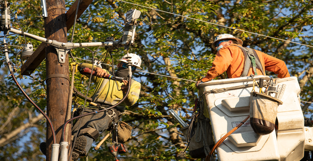 Two crew members repairing tree damage, and road closures have provided plenty of hurdles for restoring power.