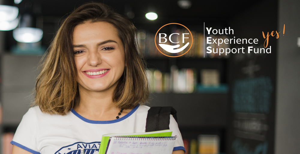 A young woman smiling with a Bainbridge Community Foundation logo that says "Youth Experience Support Fund Yes!" to the right side of the image. 