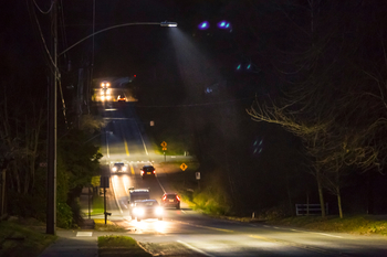 New LED streetlights focus light on the dark roadway. 