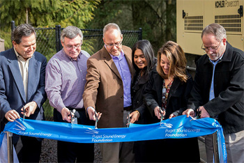 Representatives from PSE Foundation, PSE, Island Church, the City of Bainbridge Island and Kitsap County cut a wide, blue ribbon at the unveiling of the Island Church high-capacity generator.
